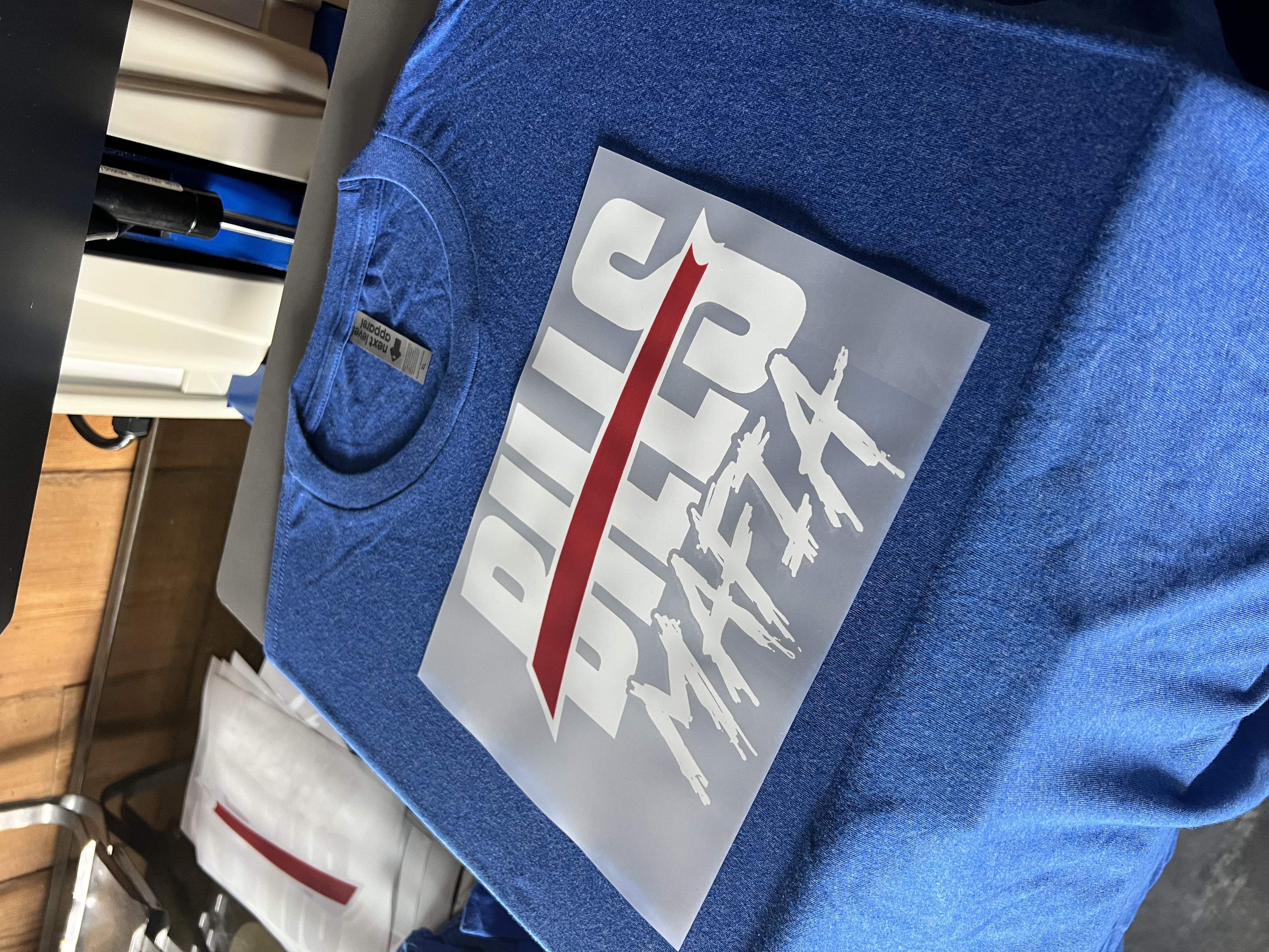 Bills Mafia transfer positioned on a blue shirt at the heat press