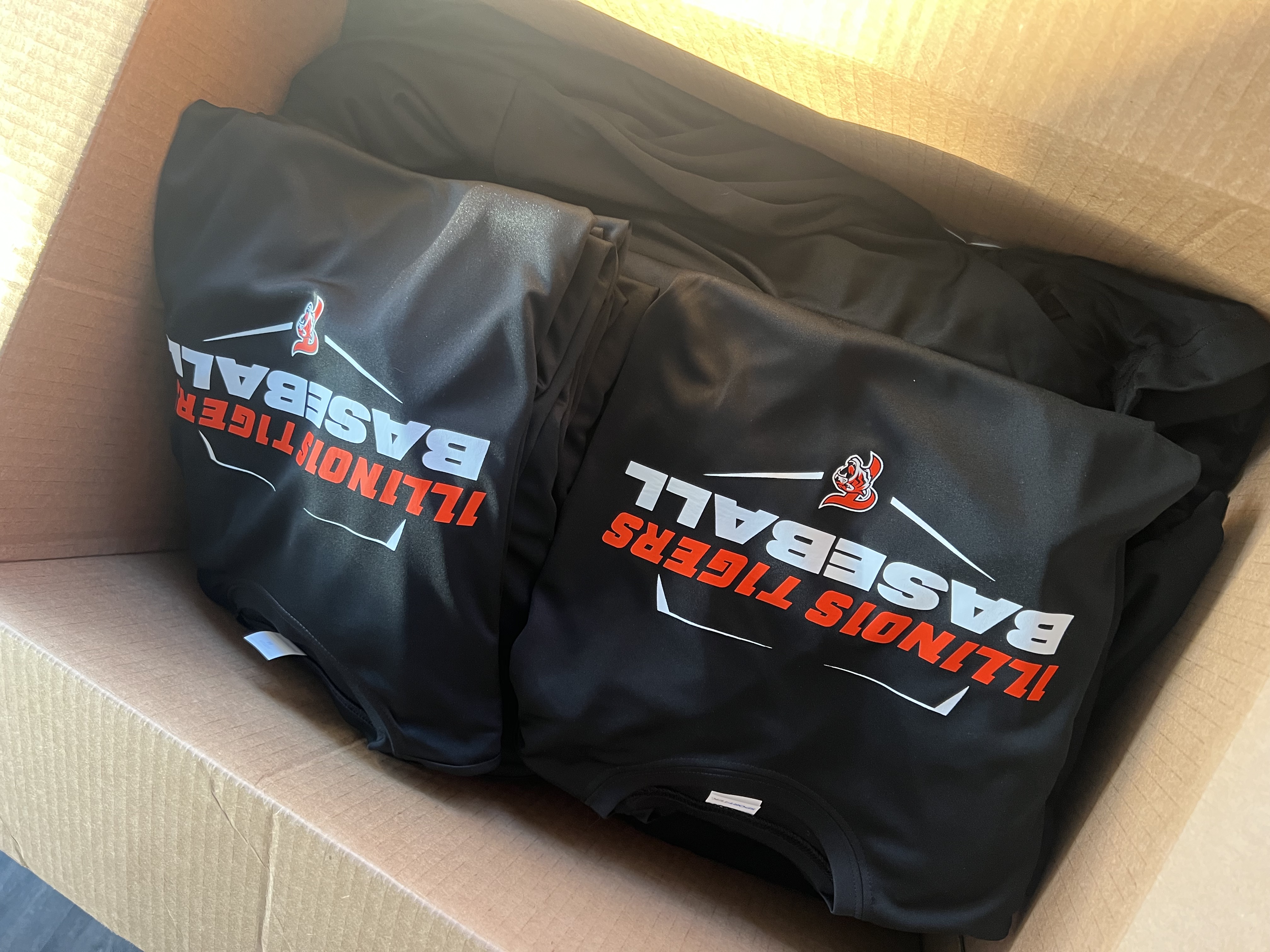Finished Illinois Tigers apparel packed in a shipping box